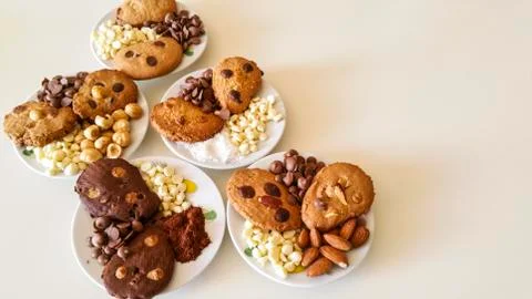 Biscuits with chocolate chips and almonds, hazelnuts or cocoa powder Stock Photos