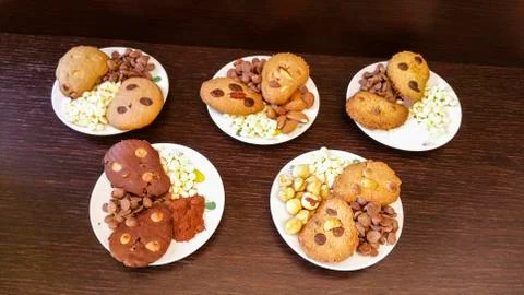 Biscuits with chocolate chips and almonds, hazelnuts or cocoa powder Photos