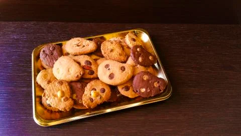 Biscuits with chocolate chips and almonds, hazelnuts or cocoa powder Stock Photos