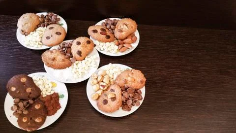 Biscuits with chocolate chips and almonds, hazelnuts or cocoa powder Stock Photos