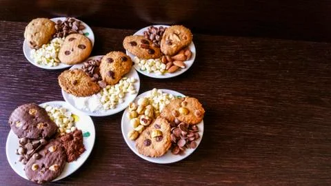 Biscuits with chocolate chips and almonds, hazelnuts or cocoa powder Stock Photos