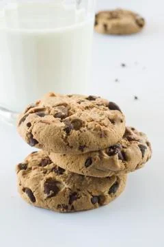 Biscuits with chocolate chips inside and a glass of milk. Stock Photos