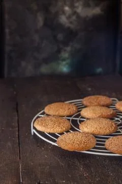 Biscuits on a grate for baking on a dark background, retro style, vintage Stock Photos