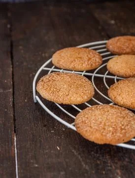 Biscuits on a grate for baking on a dark background, retro style, vintage Stock Photos