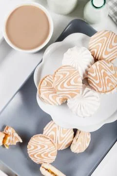 Biscuits on gray plate with cups of coffee, top view Stock Photos