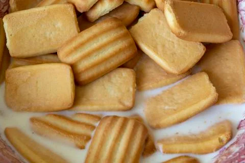 Biscuits in milk Fotos Stock