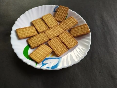 Biscuits in a plate, black background Stock Photos