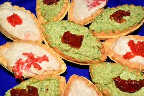 Biscuits in the shape of boat stuffed with various creams 库存照片