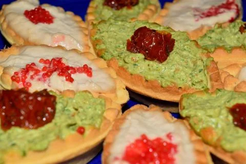 Biscuits in the shape of boat stuffed with various creams Stockfoto's