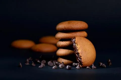 BISCUITS - Stack of delicious cream biscuits filled with chocolate cream on b Stock Photos
