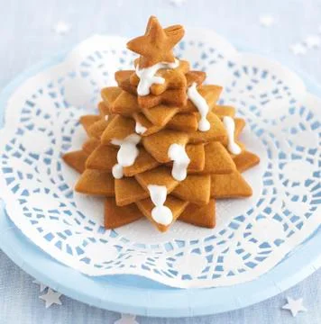 Biscuits stacked in the shape of a Christmas tree with icing sugar Stockfoto's