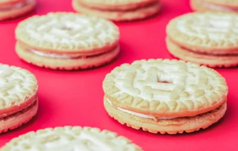 Biscuits with stuffing on red background Stock Photos