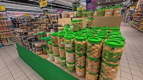 Biscuits in transparent plastic containers are tiered by brand, type, and price Stock Footage 310537167