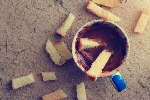 Biscuits was dipped in hot chocolate cup, top view Fotos de archivo