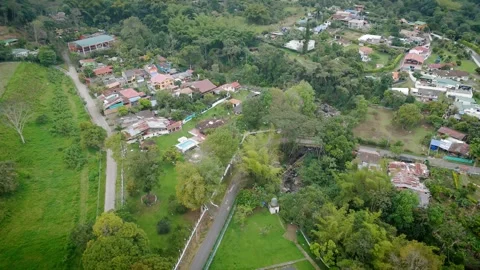 Bisecting Main Artery Through Compact Village Amid Lush Foliage Video stock 316864698