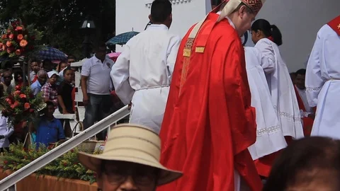 A bishop and a group of altar boys during an open-air mass Stock Footage 86519081
