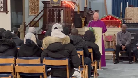 Bishop of Woolwich leads prayers at a vigil for murdered teenager Kelyan Bokass Stock Footage 297321961