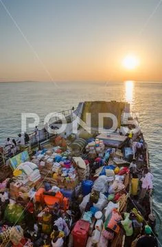 Bissau, Guinea Bissau - December 06, 2013: Old ferry heavily loaded on journey Stock Photos
