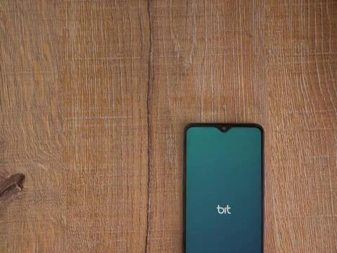 Bit app launch screen with logo on the display of a black mobile smartphone o Stock Photos