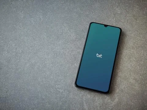 Bit app launch screen with logo on the display of a black mobile smartphone o Stock Photos
