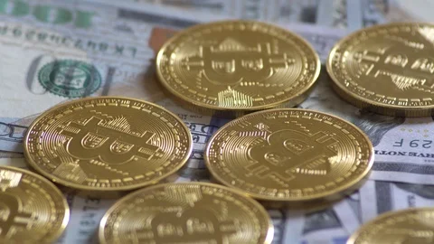 Bit Coin BTC coins rotating on bills of dollars. Virtual cryptocurrency. Stock Footage 88802784