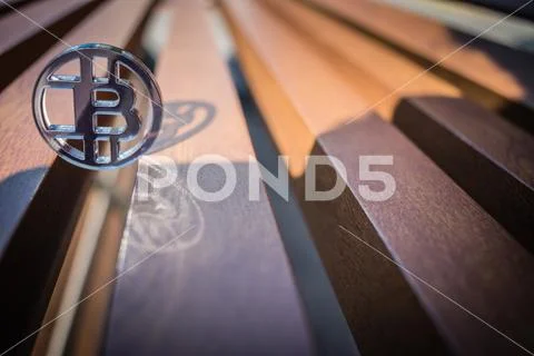 Bit coin plastic and its reflection on sunlight Stock Photos