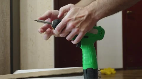 Bit replacement in cordless screwdriver at home. Stock Footage 334339323