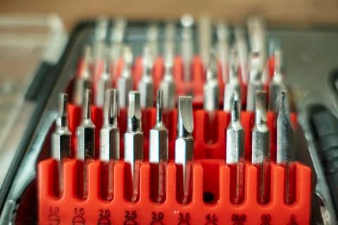Bit set with different screws Bits in a red plug box Toolbox 스톡 사진