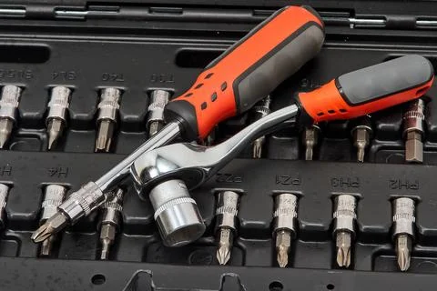 Bit set, screwdriver, wrench in a plastic case Stock Photos