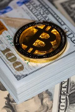 Bitcoin on 100 dollar bill background Stock Photos