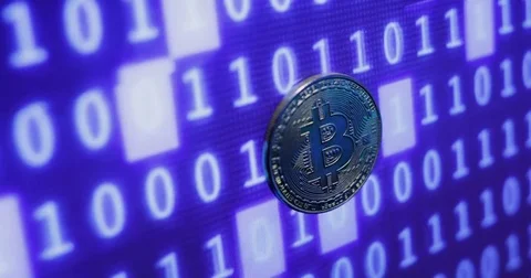 Bitcoin against monitor with binary code. Crypto currency Gold Bitcoins - BTC - Stock Footage 82912581