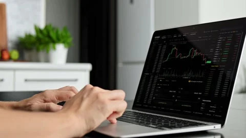 Bitcoin and cryptocurrency volatility. Young woman sits at laptop at home and Видео 219608572