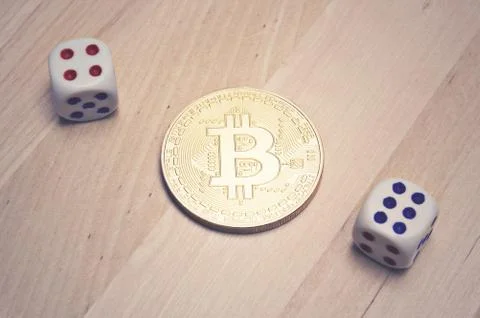 Bitcoin and dice on table Stock Photos