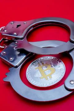 Bitcoin and handcuffs Stock Photos