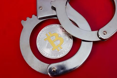 Bitcoin and handcuffs Stock Photos