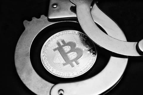 Bitcoin and handcuffs Stock Photos