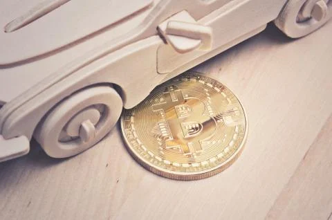 Bitcoin and mini car on table Stock Photos