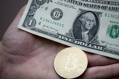 Bitcoin and one dollar currency of the world. Stock Photos