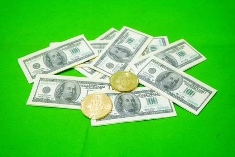 Bitcoin and US Dollar isolated on green background Stock Photos