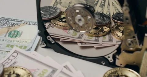 Bitcoin and US Dollar reflecting on Hard drive platter, cost of computer parts Stock Footage 172132756