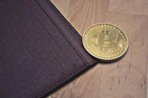 Bitcoin and wallet on table Stock Photos