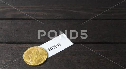 Bitcoin and written the word: Hope on paper. Stock Photos