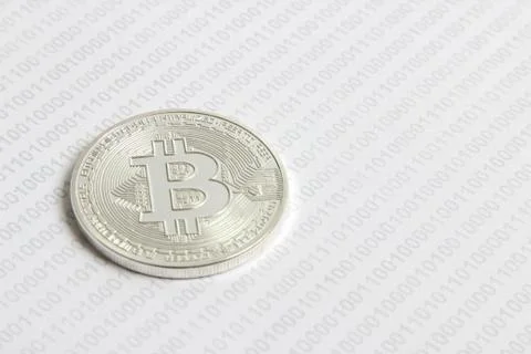 Bitcoin on the background of binary code Stock Photos