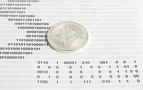 Bitcoin on the background of binary code Stock Photos
