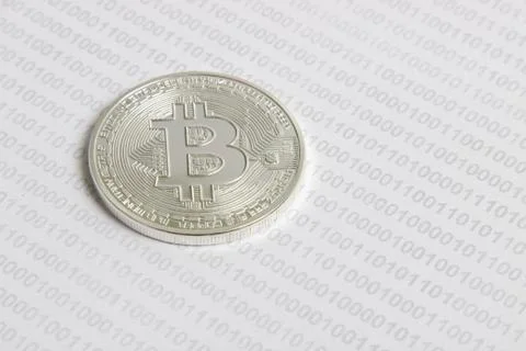 Bitcoin on the background of binary code 写真素材