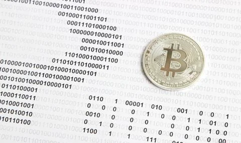 Bitcoin on the background of binary code Stock Photos