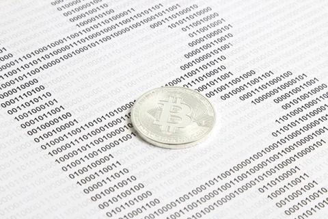 Bitcoin on the background of binary code Stock Photos