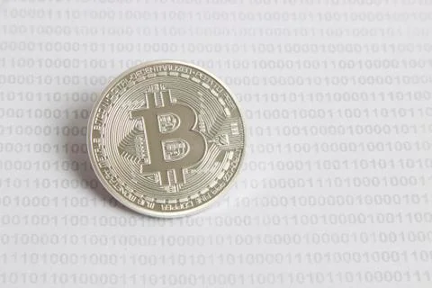 Bitcoin on the background of binary code Stock Photos