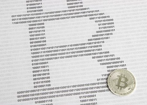 Bitcoin on the background of binary code Stock Photos