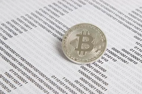 Bitcoin on the background of binary code Stock Photos